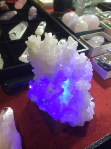 milky white Aragonite cluster lit from beneath by a light box